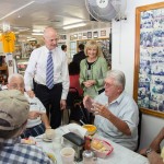 Commissioner Sandy Murman and Florida Governor Rick Scott listen to residents during lunch at the West Tampa Sandwich Shop.