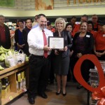 Sandy presents a "You Make the Difference" award to store manager Rick Rescingo at the Swann Avenue Winn Dixie Ribbon Cutting Ceremony.