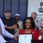 Commissioner Sandy Murman and Commissioner Mark Sharpe present Tampa Hillsborough Homeless Initiative CEO, Antoinette Triplett with a proclamation designating November as Homeless Awareness Month during Operation Reveille, which housed 70 homeless veterans in one day.