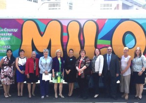 Sandy helps community leaders and county staff launch the MILO (Mobile Interactive Literacy Opportunity) bus to bring books to underserved children in at-risk communities.