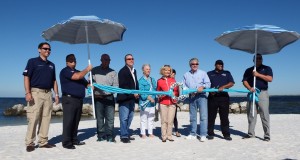 Sandy Murman, along with members of the Apollo Beach Waterway Improvement Group (ABWIG) and County Parks, took part in a special "Beach-Towel Cutting" to re-open Apollo Beach.