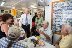 Commissioner Sandy Murman and Florida Governor Rick Scott listen to residents during lunch at the West Tampa Sandwich Shop.