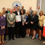 Sandy presents the Small Business Week proclamation before the BOCC.