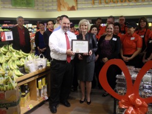 Sandy presents a "You Make the Difference" award to store manager Rick Rescingo at the Swann Avenue Winn Dixie Ribbon Cutting Ceremony.
