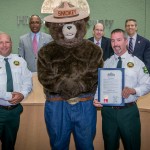Sandy proclaims “Smokey Bear Day” in Hillsborough County, celebrating Smokey’s 70th birthday, and encouraging citizens to be careful when using fire in rural areas. From left are: Commissioner Murman, John Dewolf of the Florida Forest Service, Smokey Bear, Pat Keogh of the FFS, and Mike Facente, Forest Ranger for the FFS.
