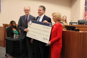 On behalf of Hillsborough County, Commissioner Sandy Murman and County Administrator Mike Merrill accept a check for $113,185.79 from State of Florida Chief Financial Officer Jimmy Patronis. The funds are from the State’s Unclaimed Property Fund and are sourced from a variety of accounts in the county’s name.